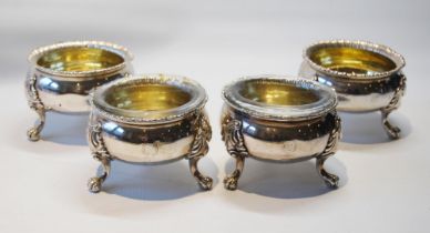 Set of four silver salts of good gauge with gadrooned edges on scrolling paw feet, crested, one by