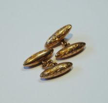 Pair of gold engraved torpedo cufflinks, '10ct', 5g.