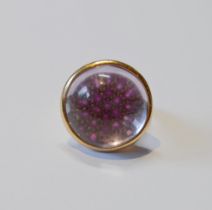 18ct gold dress ring with a pavé cluster of rubies magnified under a rock crystal cabochon, by