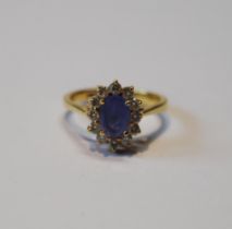 Diamond and Ceylon sapphire oval cluster ring, uncertificated, in gold, '18k', 4.8g gross.