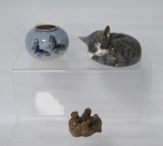 Three pieces of Royal Copenhagen porcelain modelled as a sleeping cat, a bear and an oviform spill