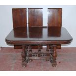 Antique-style oak extending dining table with three additional leaves, on central balustrade