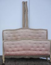 French painted double bed with pink padded button back to each end, foliate appliques to the