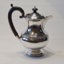 Silver hot water pot of baluster shape with embossed floral bands, Birmingham 1931, 376g.