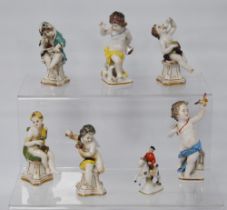 Pair of 19th century Naples porcelain figures modelled as scantily-clad putti with a bird and dog,