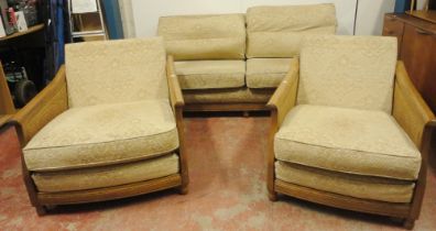 Ercol teak and bergère three-piece suite comprising a large settee and a pair of armchairs, fabric-