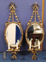 Pair of gilt metal girandole wall mirrors in the 18th century style, each with floral and ribbon
