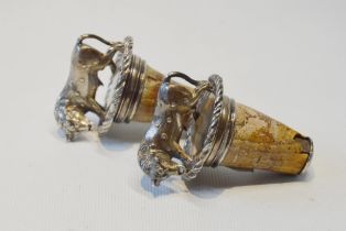 Pair of bottle corks with heavy silver mounts, each modelled as a spotted bull, by William Eley,