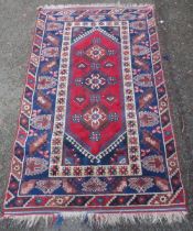 Turkish Belouch hand-knotted rug with three geometric lozenges to the centre, flanked by a band of