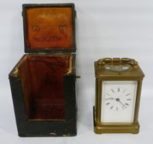 Brass four glass carriage clock with movement viewing window to the top, 12cm high, with tooled