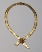 9ct gold necklace of textured brick pattern, with gem-set slide, 50g gross.