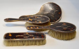 Silver-mounted tortoiseshell four-piece brush and mirror set with inlaid decoration, Birmingham