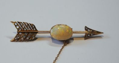 Victorian gold arrow brooch with an opal (16mm x 11mm) and diamond points, probably 18ct gold, 65mm,