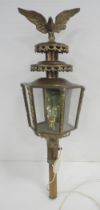 Brass carriage lamp with eagle surmount and hexagonal glazed tapered sides, probably of German