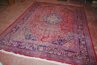 Persian Kashan hand-knotted carpet with large floral medallion to the centre, surrounded by