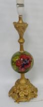 Moorcroft 'Hibiscus' table lamp with spherical tube-lined column on green ground, 41cm high.