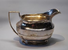 Silver cream jug of rounded rectangular shape, by R & E Barnard, 1816, 125g.