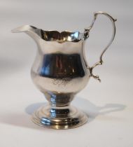 Silver baluster cream jug with cut edge and scroll handle, on reeded foot by R & D Hennell, 1763,