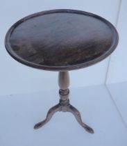 Georgian mahogany wine table with saucer top, on turned baluster column and shaped tripod