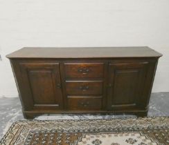 Antique 18th century style oak dresser base with three central drawers flanked by cupboard doors, on