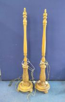 Near pair of reproduction standard lamps in the 18th century style, each on leaf carved turned