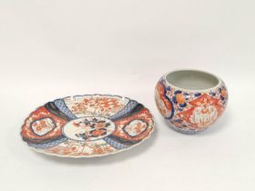 Japanese Meiji period Imari pottery serving dish, with wavy rim and foliate and landscape borders,