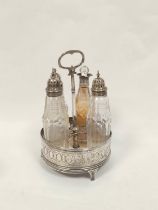 Silver circular cruet, pierced and engraved with three mounted bottles, makers mark not clear. 1794.