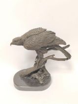 20th century cast bronze sculpture of a bald eagle, perched on naturalistic branch and on shaped