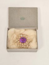 Early 19th century seed pearl brooch with foiled amethyst in gold, upon mother of pearl.