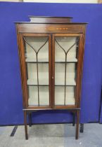 Early 20th century china cabinet with astragal glazed doors enclosing two shelves with satinwood