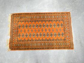 Tekke Bokhara hand knotted rug with thirteen rows of two geometric motifs on a rust ground, 164cm