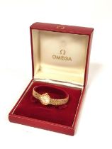 Lady's Omega 9ct gold watch on integral textured bracelet, 1960's. 23.4g gross. Original case.