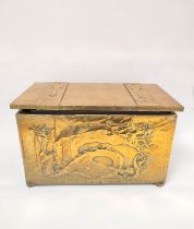 Arts & Crafts brass log box decorated with embossed panel of a dragon, applied strapwork and