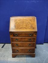 Burr walnut small bureau of early 18th century style with four graduated drawers, 21".