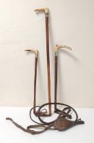 Three riding crops with antler grips circa early 20th century, one example with button badge for