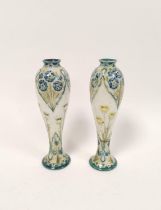 Pair of William Moorcroft for MacIntyre Florian ware vases from the Art Nouveau era, the tapered