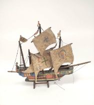 Handmade wooden model of a galleon, the hull painted with applied world flags with masts, on