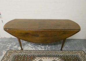 Antique style oak wake table with curved ends and extending drop leaf sides, raised on pad feet,