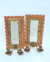 Pair of Aesthetic Movement copper and brass girandole wall mirrors, each with a wavy copper