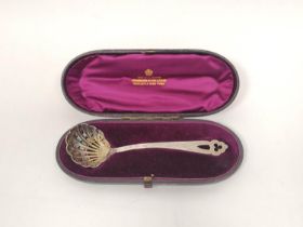 Silver sifter with scallop bowl, pierced handle by Reid, Newcastle 1880, cased.