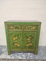 Indian style green painted and lacquered decoupage cupboard with two small drawers above cupboard