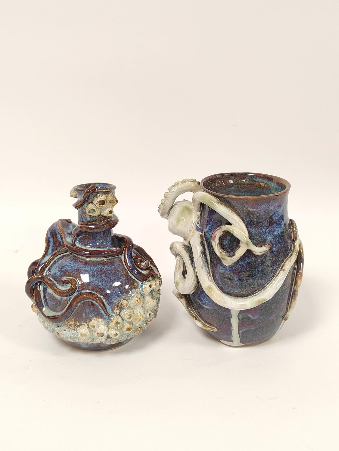 Two Studio pottery vases (Hexham?) each decorated with moulded octopus, drip glazed in blue,
