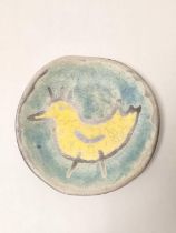 Spanish art pottery shallow dish of primitive form, decorated with a yellow cockerel against a