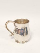 Silver mug of plain bellied shape with scroll handle, initialled by Mappin & Webb 1929. 386g. 12.