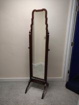 Mahogany cheval mirror with shaped arched top, in the Queen Anne manner, upon reeded supports and