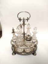 Victorian e.p. oval cruet with six cut glass condiments and spike finials. C1890.