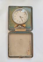 Travelling clock by Benson London, in folding square leather case with gilt monogram "M.K." below