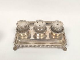 Silver inkstand, rectangular with three mounted cut glass receivers with gadrooned edges on leafy