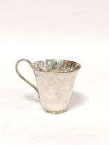 Silver christening mug of plain tapering shape, reeded handle and foot, by Elkington & Co, mid