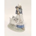 Royal Copenhagen porcelain figure group of a farming girl with two goats on a shaped base, backstamp
